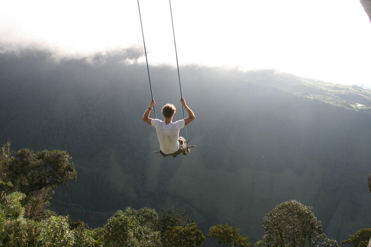 A man on a swing in the mountains of Ecuador